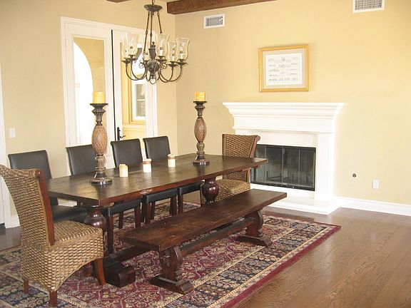 Dining room with fireplace and wood beam ceilings