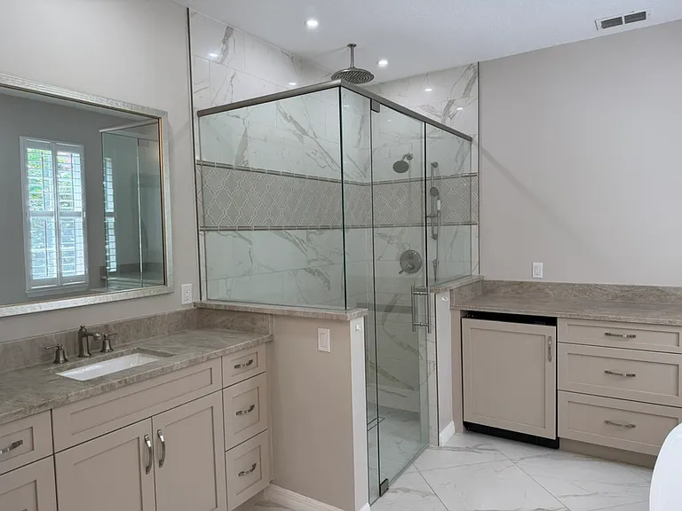 Large Primary bathroom with separate sinks. Walk-in shower with storage