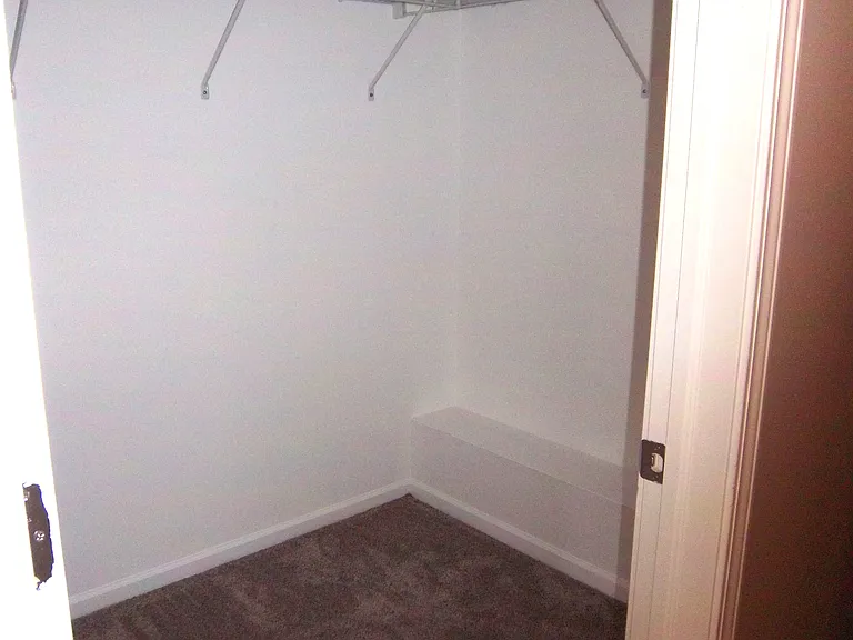Walk in closet in primary bedroom