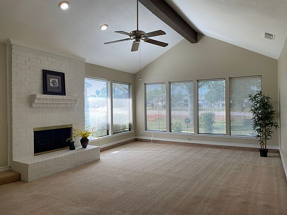Expansive living room overlooking the green park behind.
