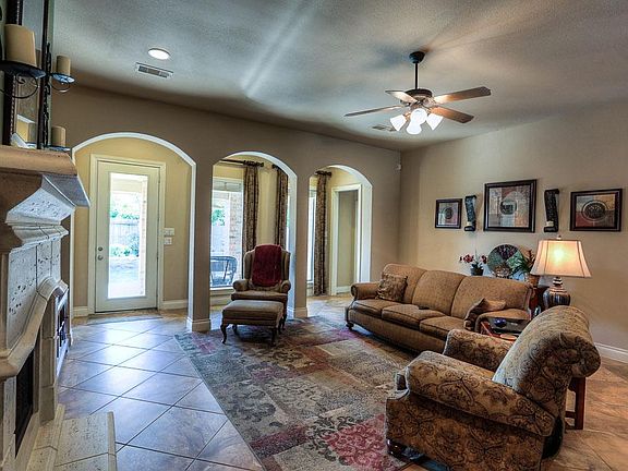 The family room with 9 foot ceilings, tile floors and a great view of the backyard pool.