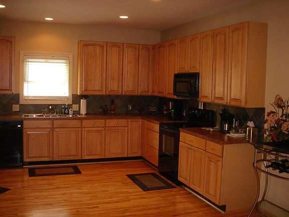 Spacious kitchen. Maple cabinets and hardwood floors.