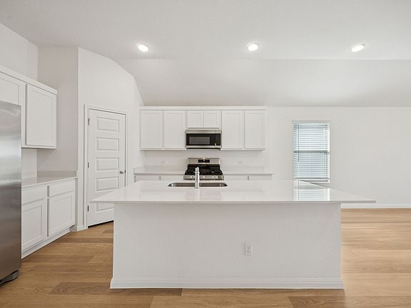 Kitchen in the Redbud home plan by Trophy Signature Homes - REPRESENTATIVE PHOTO