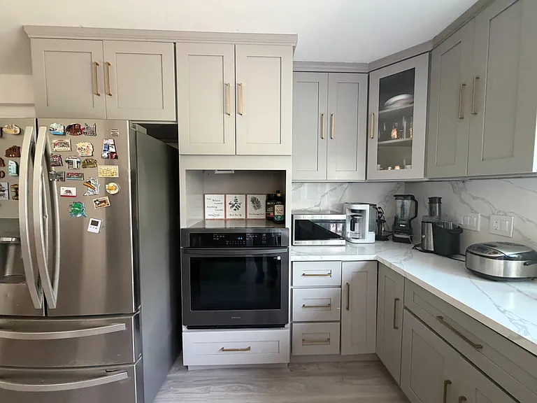 Updated kitchen with ample shaker cabinetry, stone-look counters, and stainless steel appliances for everyday cooking.