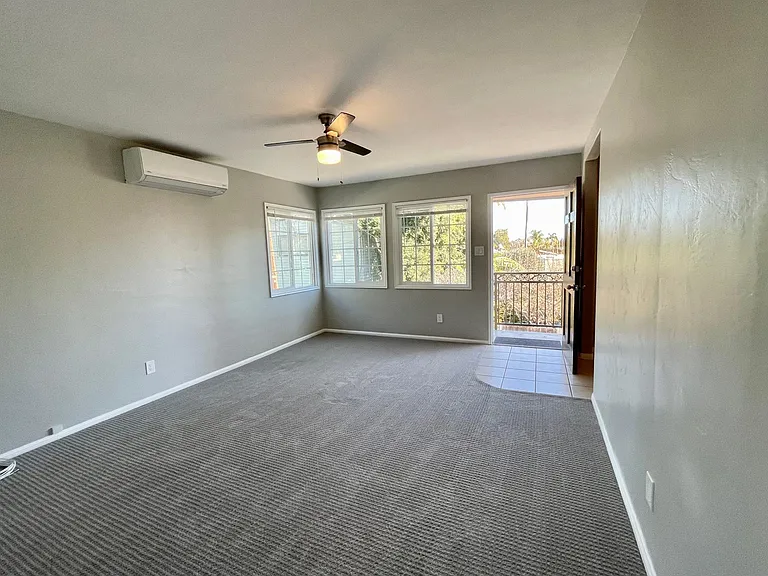Living room and entry, looking east from the bedroom door.