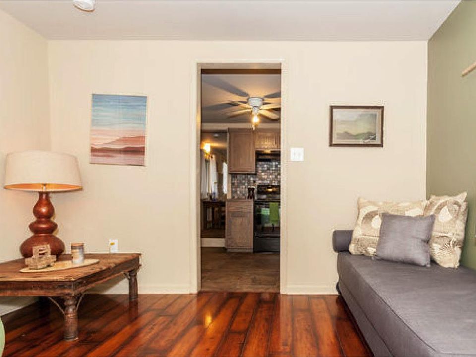 Living room with view into kitchen. The cherry flooring was replaced with wood-look tiles in 2021.