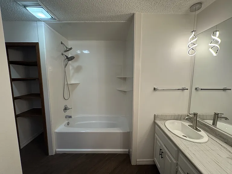 Master bath w/ shower/tub combo. Linen closet on left.