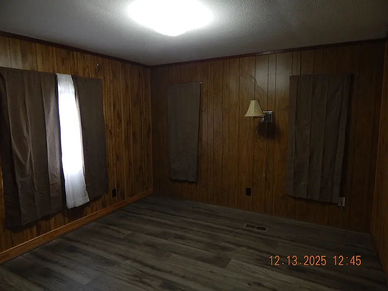 Looking from master bedroom entrance -window to south side of home & reading light next to back window.