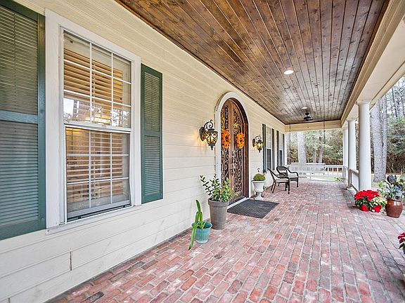 PEACE AND QUIET: Relax on the porch and enjoy this luxurious home with plenty of space for family and friends.