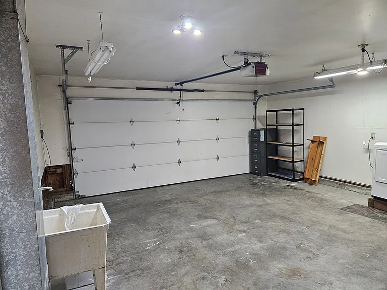 garage has utility sink and washer/dryer hook up