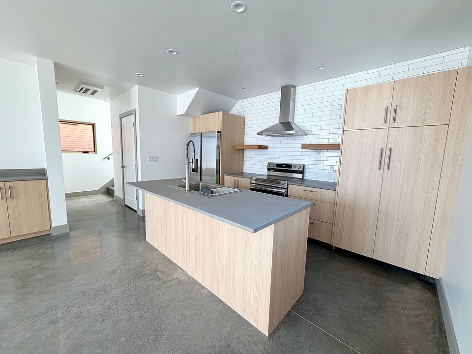 Stylish Kitchen featuring brand new appliances, custom cabinetry and concrete countertops.