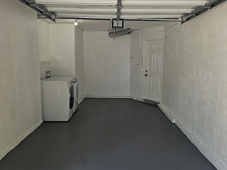 attached garage with rear door to the kitchen