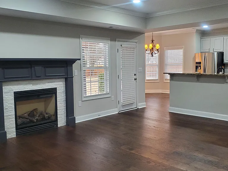 Remodeled and tiled mantle with gas log fireplace.