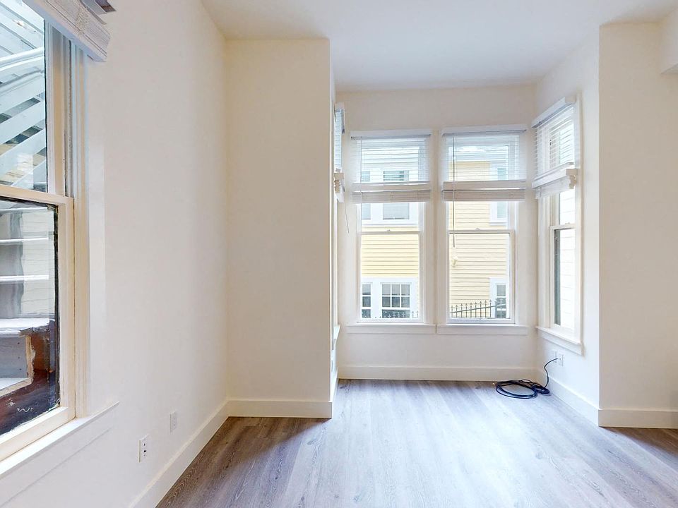 Living room with large windows and wood-like floors