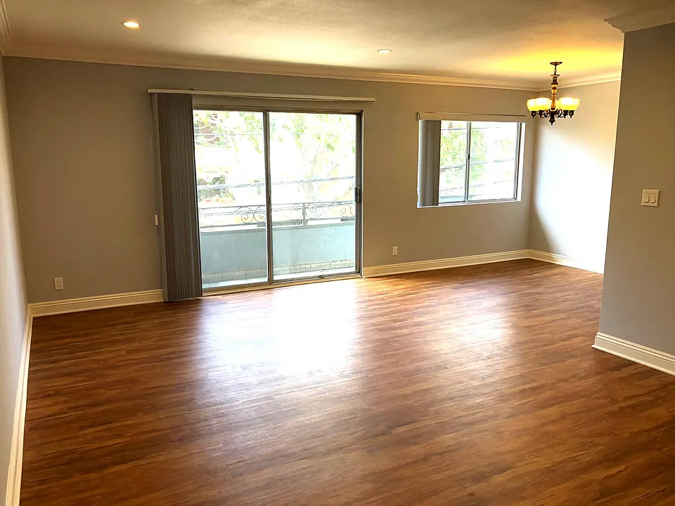 Living room dinning room with French doors that lead to balcony