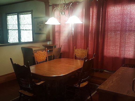 Dining room with kitchen in background