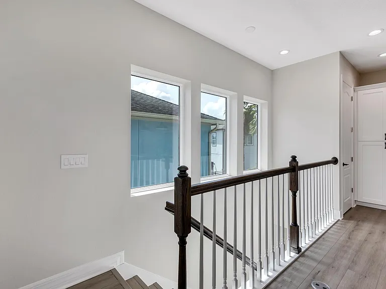 View from great room towards entry stairs and large west windows.