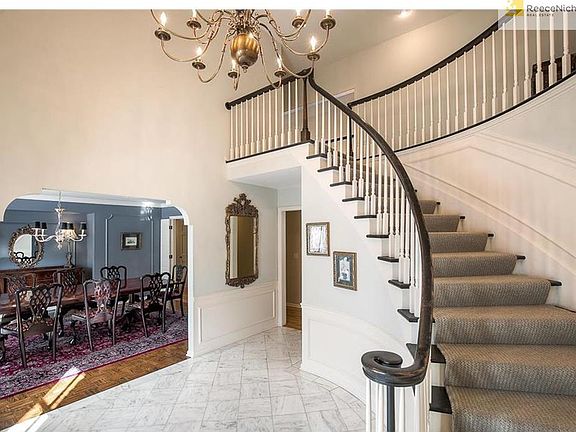 The curved staircase definitely adds the WOW factor! Notice the quaint, decorative entrance to the dining room!