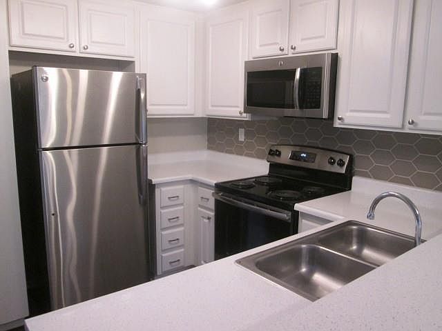 Newly Renovated White Cabinets w/ Hexagon Backsplash & Spray