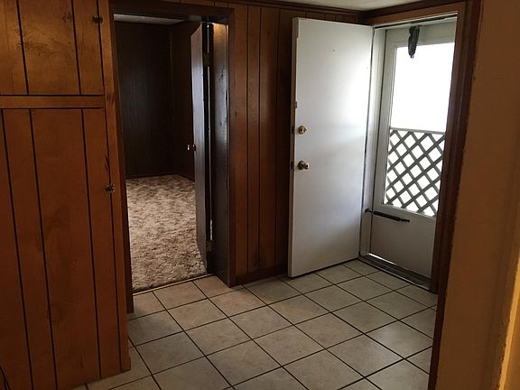 entry / mud room has storage on the left & a coat rack & she