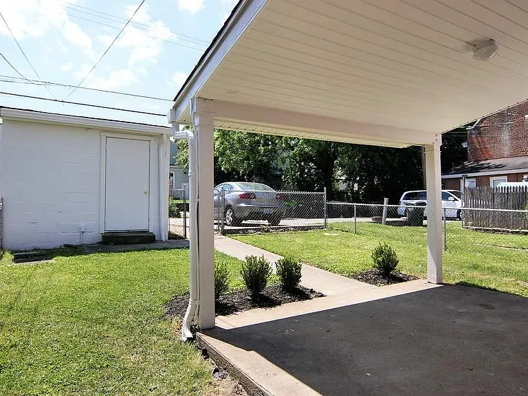 The fenced yard is perfect for kids and small pets. The garage is perfect extra storage or parking for a compact car. The parking pad beside it is all yours.