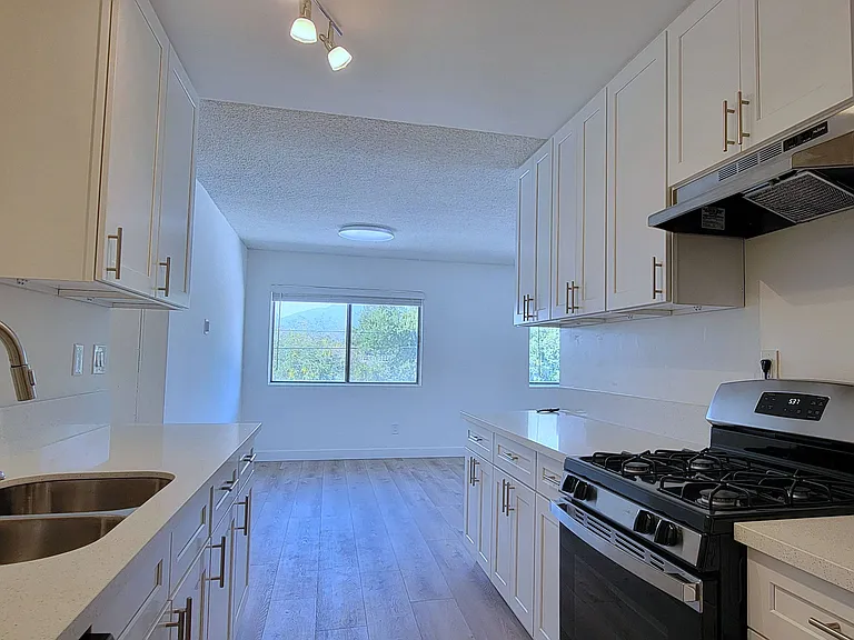 Kitchen with plenty of white cabinets at the Hardison Apartments in Pasadena, California.