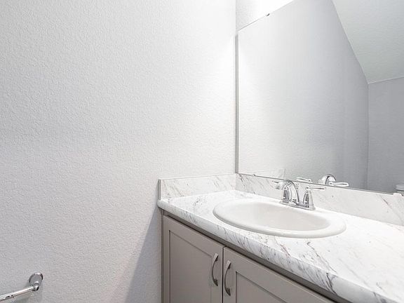Convenient downstairs powder room for guests - Seabrooke home plan by Highland Homes