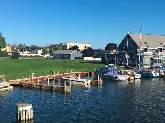 View of condo, docks and garage
