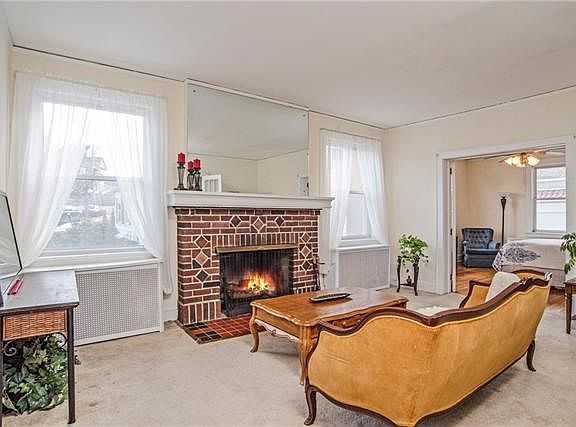Huge living area with fireplace flanked by new windows