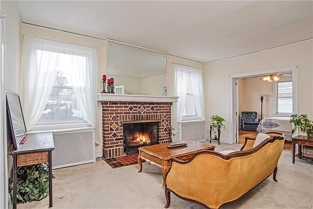 Huge living area with fireplace flanked by new windows