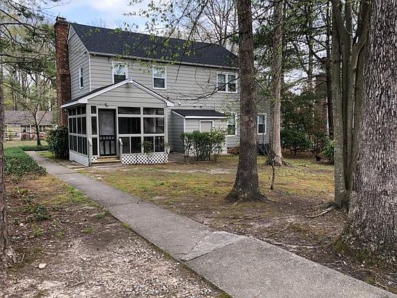 Backyard for lower level unit with parking area