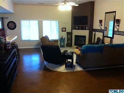 Living Room with cozy fireplace. Owner did unique floor treatment in heavy traffic areas!