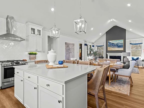 Kitchen with large island adjacent to dining area and great room