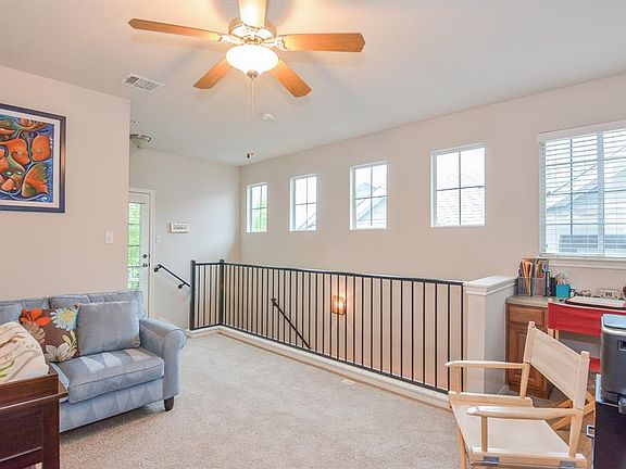 Upstairs game room with built-in desk area, highlights the natural light throughout this home.