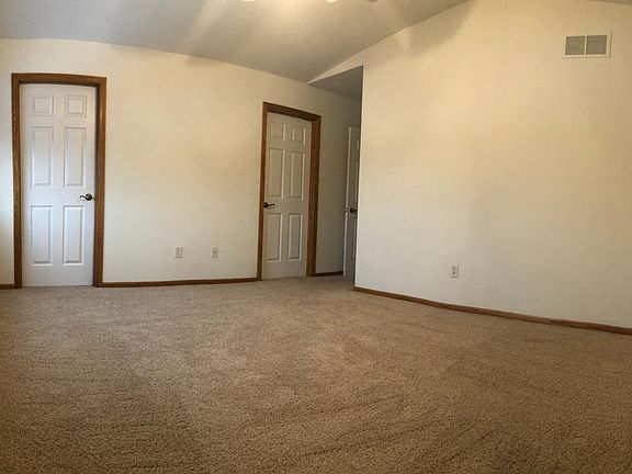 Master suite with tall pitched roof ceilings. closet on the left and master bathroom on the right.