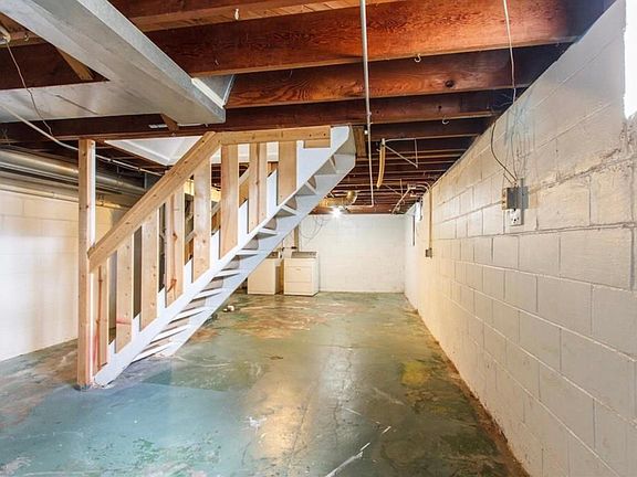 large open concept basement with additional storage room. washer and dryer in basement.