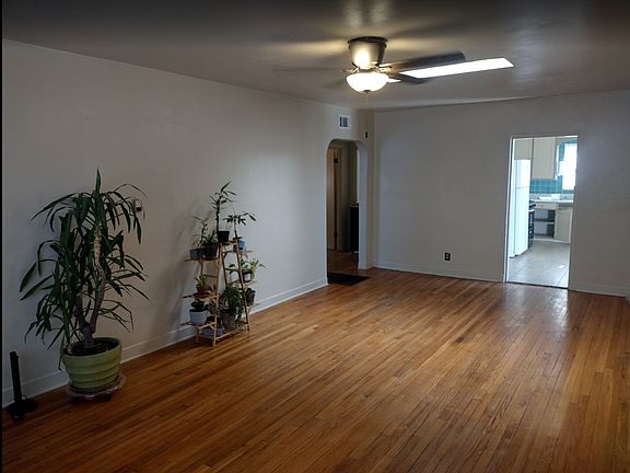 Living room with skylight opens to kitchen