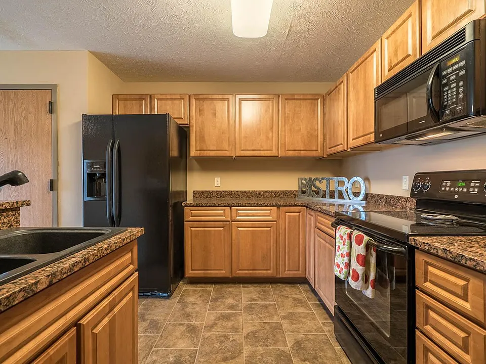 Our kitchens offer abundant cabinetry and modern black appliances, ideal for all your cooking needs.