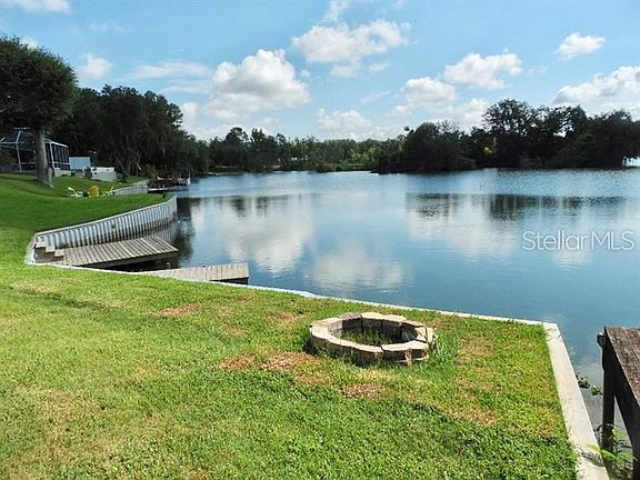 Back yard with fire pit overlooking dock