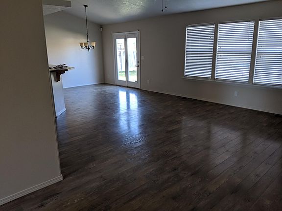 Open Kitchen with Breakfast Bar, Dining and Living Area. Bright natural light and windows.