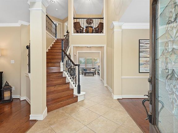 A step through the wooden-front door with in-laid glass reveals a spacious foyer, high ceilings, wood & tile floors, wrought-iron details and plenty of natural light - a theme consistent throughout the home.