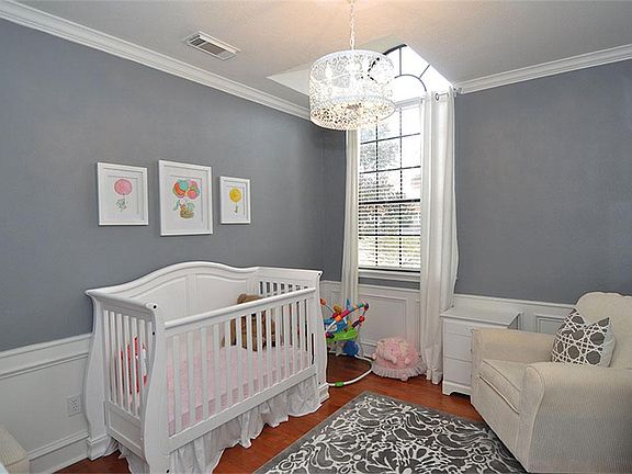 The study is wainscoted and has wood floors and a high window. (it is currently being used as a nursery.)