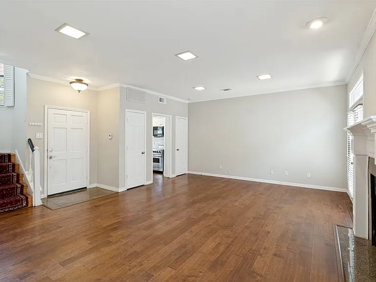 Wood floors with wood burning fireplace. Powder bath located under the stairs.