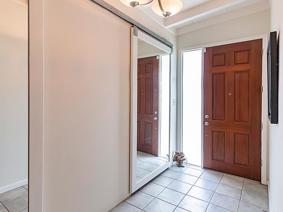 sliding door storage behind mirrored doors at entry!