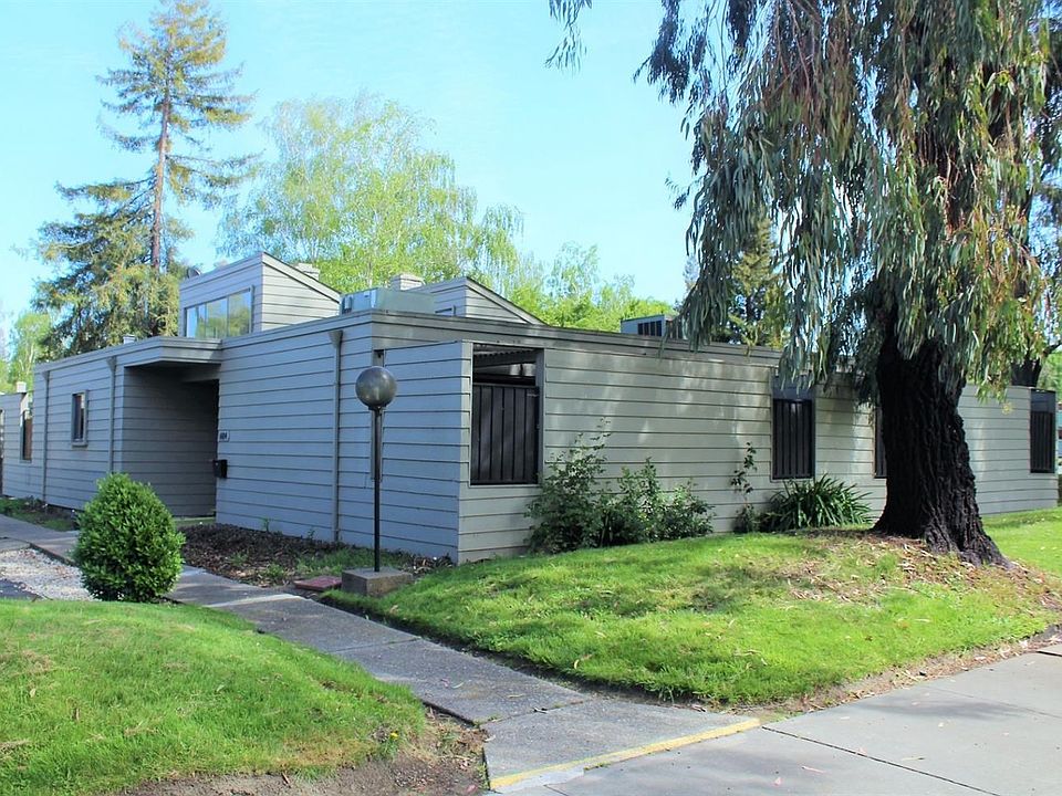 From the street, trees in abundance and ranch style charm.