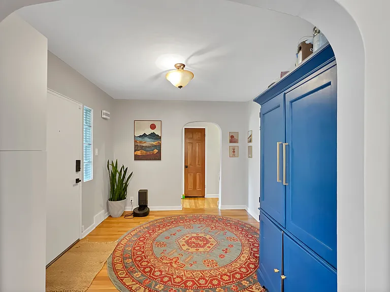 Front entry foyer with coat closet and storage cabinet.