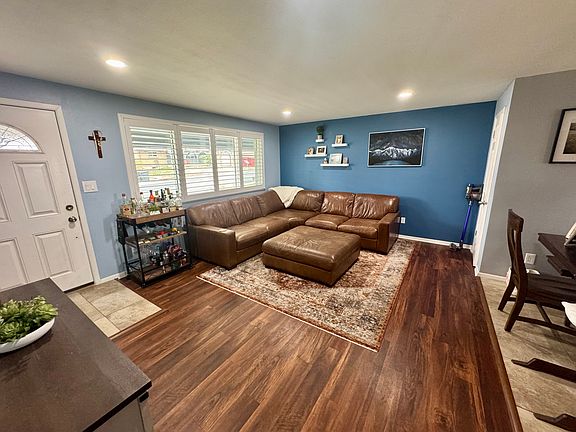Entryway from the front door into the living room with plantation shutters