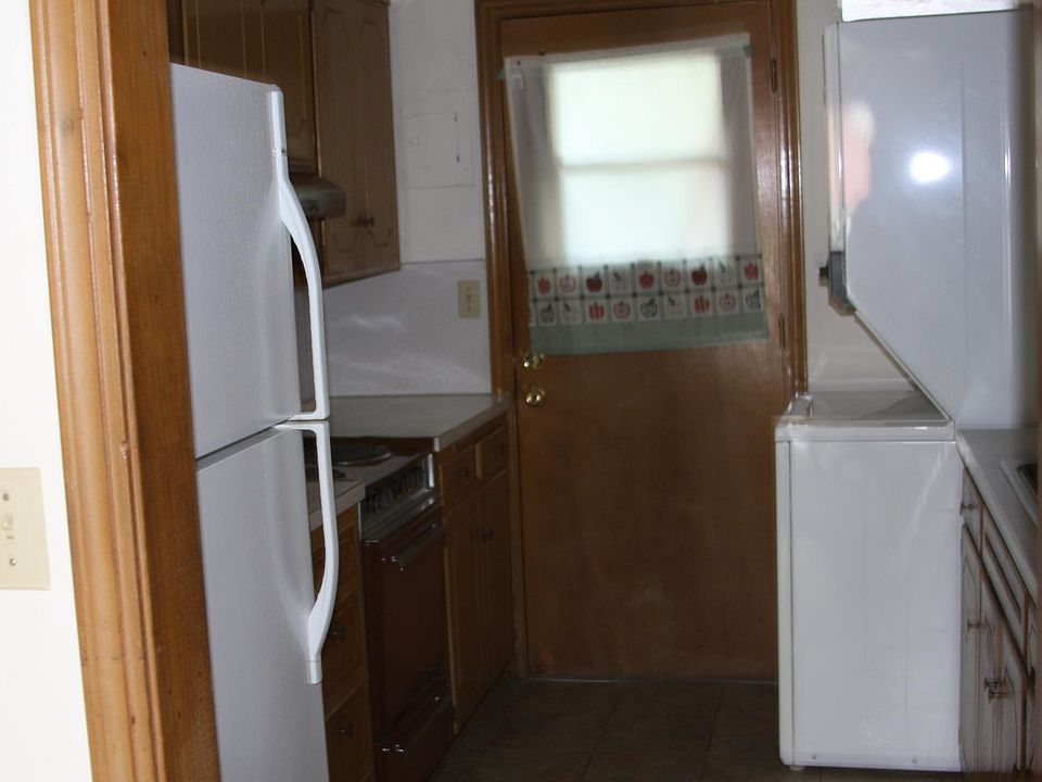 Kitchen with full size washer and full size dryer, nice frig. with ice maker. door accesses double sided fenced yard, common areas.