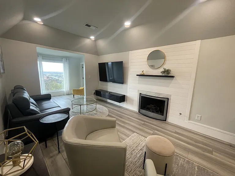 Gas Log Fireplace, 75" LG TV, Electric reclining sofa, floating entertainment center, Sunroom with beautiful views of downtown