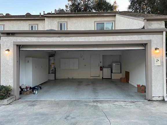 Spacious attached 2 car garage with epoxy flooring and storage. In-unit laundry washer and dryer.
